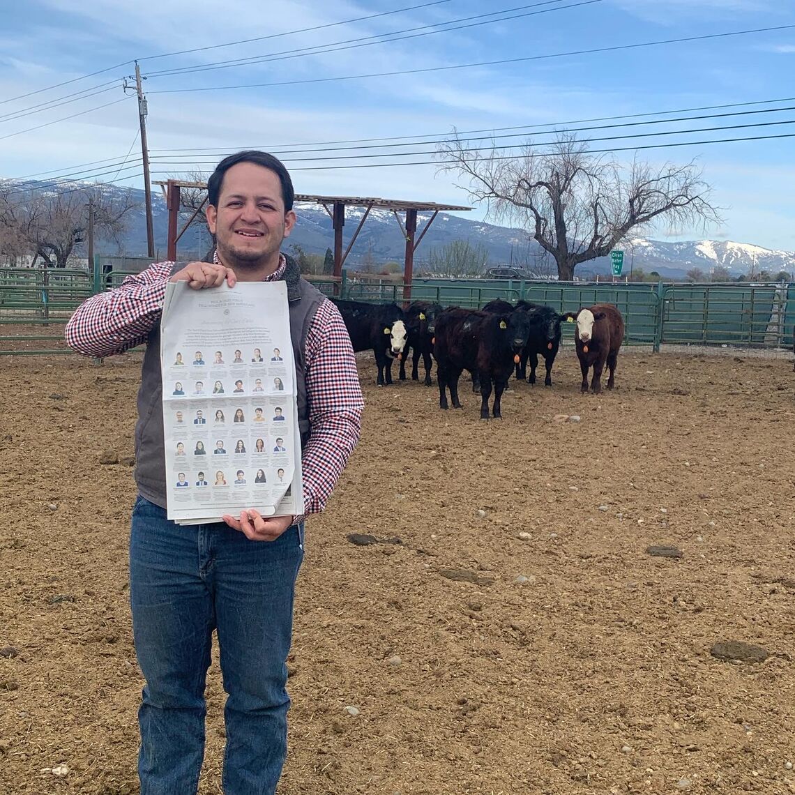 Arturo Macías Franco with New York Times Ad in Cattle Field