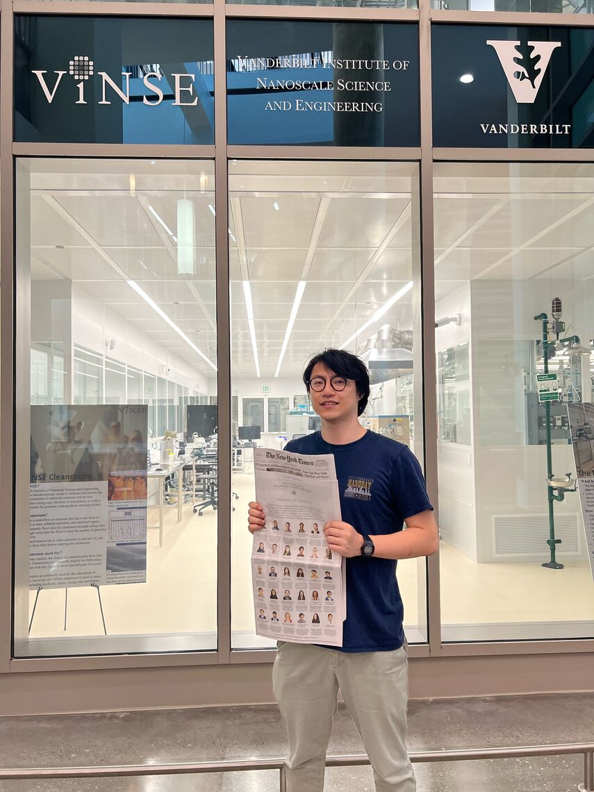 Tao Hong with the New York Times Advertisement In Front of the Vinse Classroom
