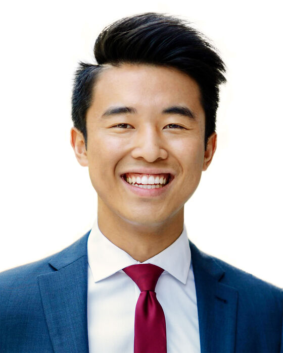 A headshot of Jimmy Lin who is wearing a red tie, white collared shirt, and blue suit jacket.