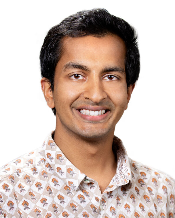 A headshot of Dhruv Gaur who is wearing a collared shirt with a floral pattern.