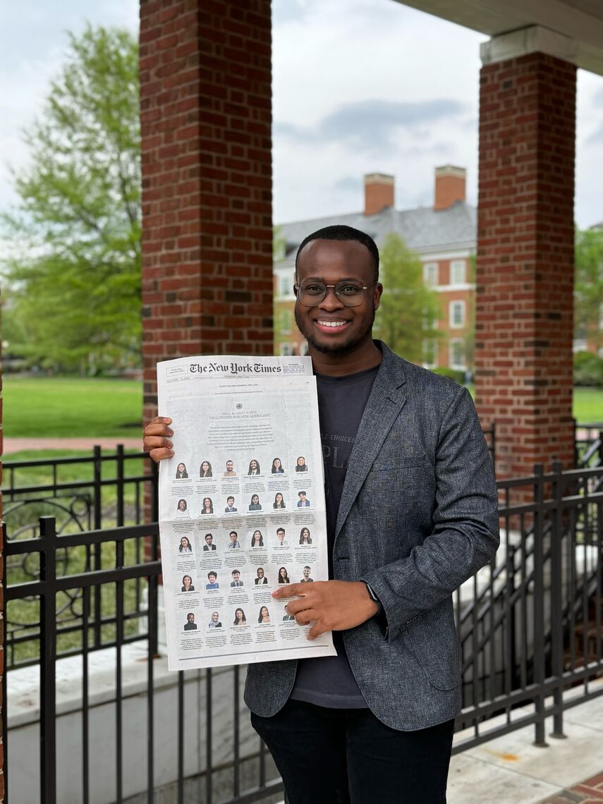 james occean holding the new york times advertisement on the johns hopkins campus where he is finishing his masters