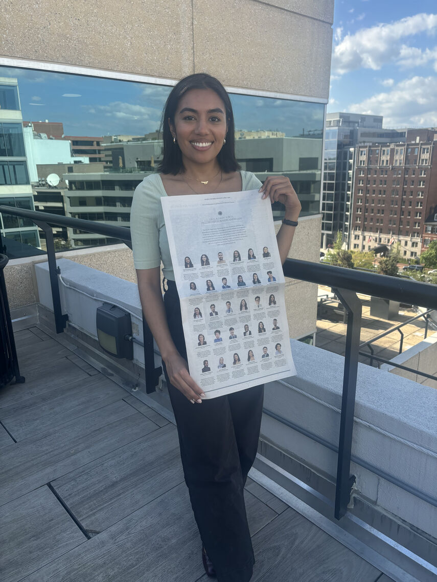 ananya agustin malhotra and the new york times advertisement she is standing on a balcony at the quincy institute for responsible statecraft s office in washington dc